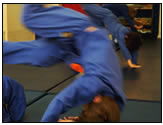 children practsing judo rolls or ukemi